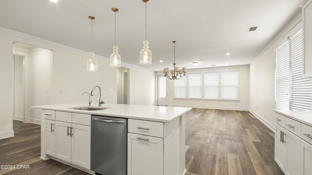 kitchen featuring dishwasher, pendant lighting, dark hardwood / wood-style flooring, a kitchen island with sink, and sink