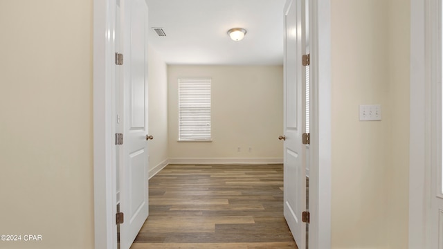 corridor featuring dark hardwood / wood-style floors