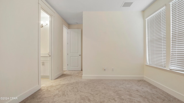 unfurnished room with light carpet