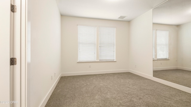 carpeted empty room featuring a healthy amount of sunlight