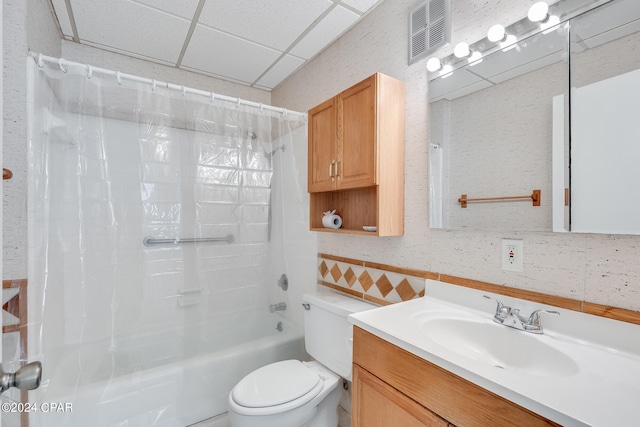 full bathroom featuring vanity, a paneled ceiling, toilet, and shower / tub combo