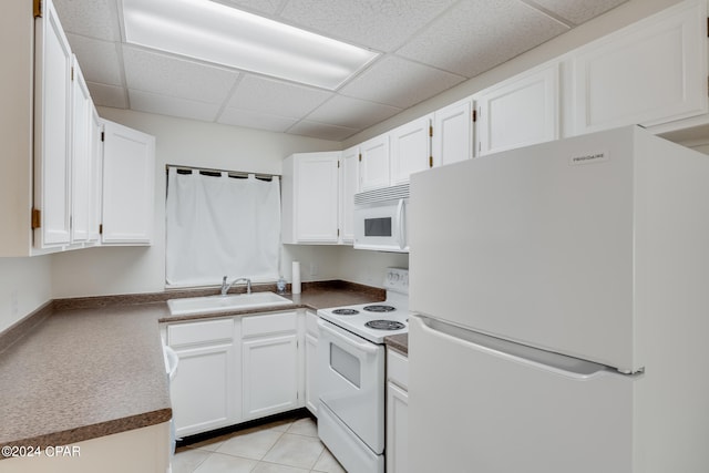 kitchen featuring a drop ceiling, white appliances, white cabinetry, and sink