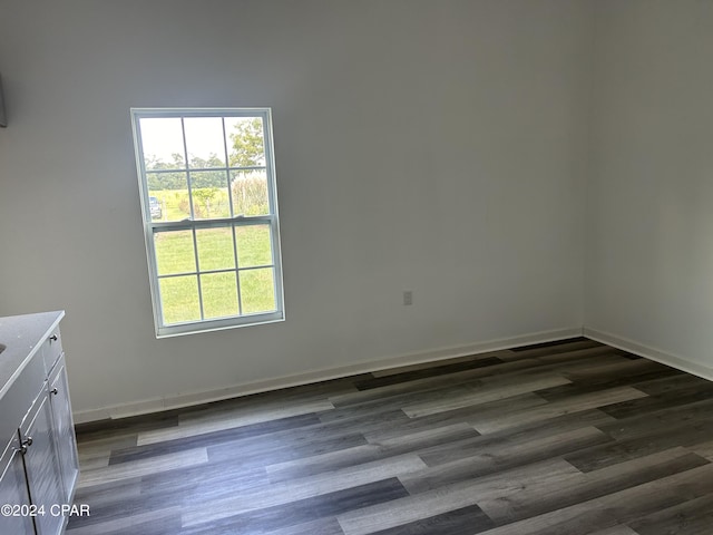 empty room featuring baseboards and wood finished floors