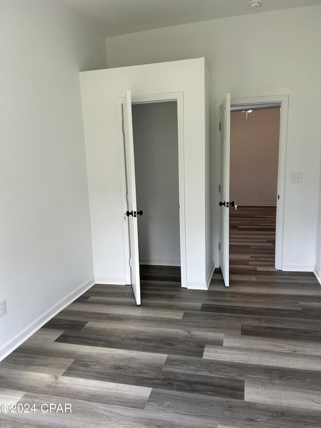 unfurnished bedroom featuring baseboards and wood finished floors