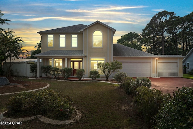 view of front of house featuring a lawn and a garage