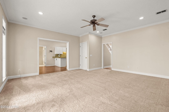 unfurnished bedroom with light carpet, a textured ceiling, ceiling fan, and crown molding