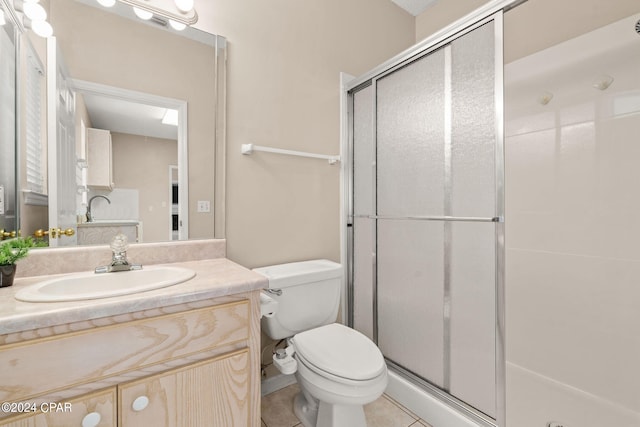 bathroom with vanity, tile patterned floors, an enclosed shower, and toilet