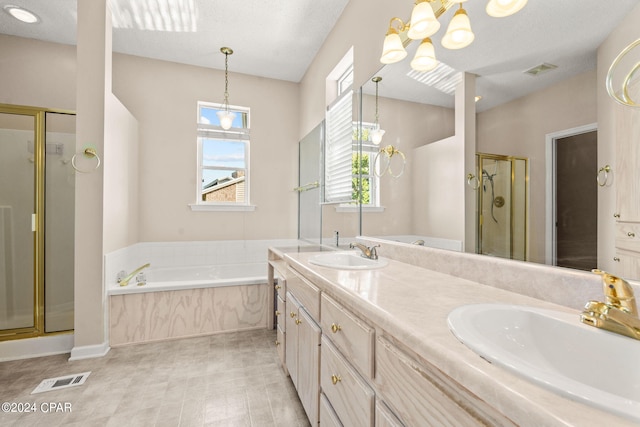 bathroom with a textured ceiling, vanity, and plus walk in shower