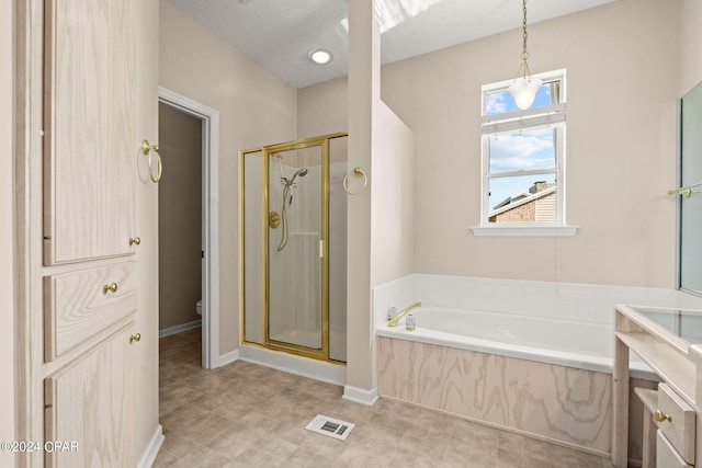 full bathroom featuring a textured ceiling, shower with separate bathtub, vanity, and toilet