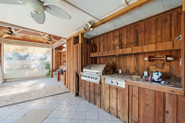 interior space featuring wood walls and ceiling fan