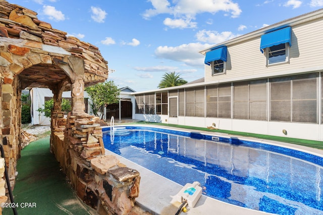 view of pool with a sunroom