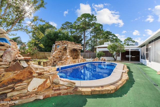 view of swimming pool with a patio area and an outdoor stone fireplace