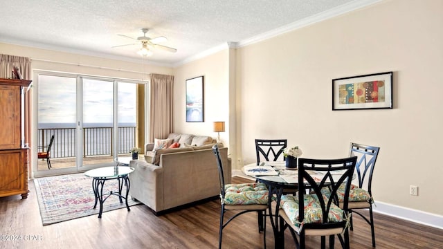 dining area with ceiling fan, a textured ceiling, crown molding, and dark hardwood / wood-style flooring