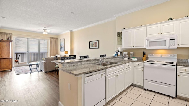 kitchen featuring white cabinets, white appliances, kitchen peninsula, a textured ceiling, and ceiling fan