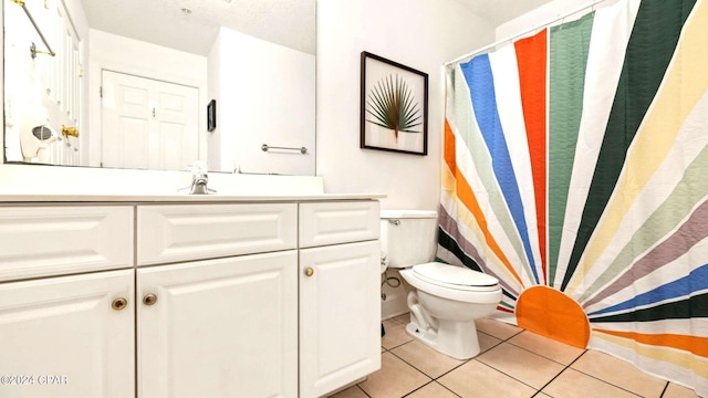 bathroom with tile patterned floors, vanity, and toilet