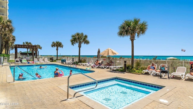 view of pool featuring a water view and a patio area