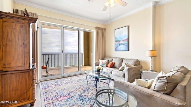 living room featuring ceiling fan, a textured ceiling, and crown molding