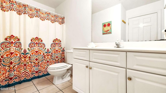 bathroom with walk in shower, vanity, toilet, and tile patterned floors