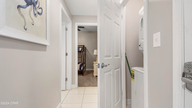 interior space with stacked washing maching and dryer and light tile patterned floors