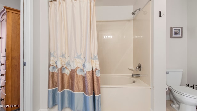 bathroom featuring tile patterned floors, toilet, and shower / tub combo