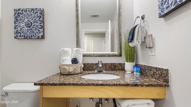 bathroom featuring toilet and vanity