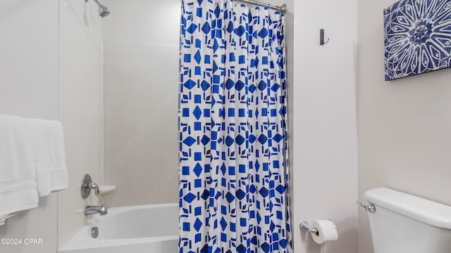 bathroom with toilet and shower / bath combination with curtain