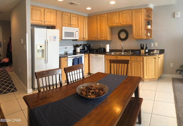 kitchen featuring sink, white appliances, and light tile patterned floors