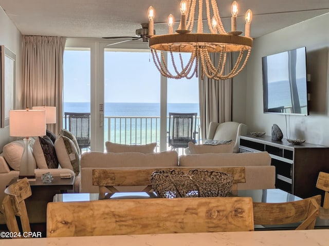 living room featuring ceiling fan with notable chandelier