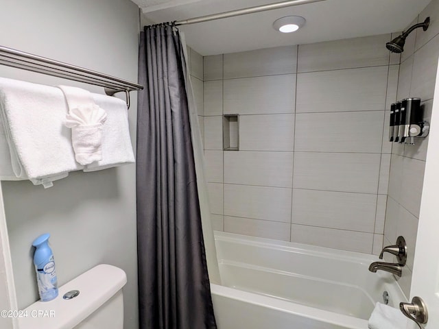 bathroom with shower / bathtub combination with curtain and toilet