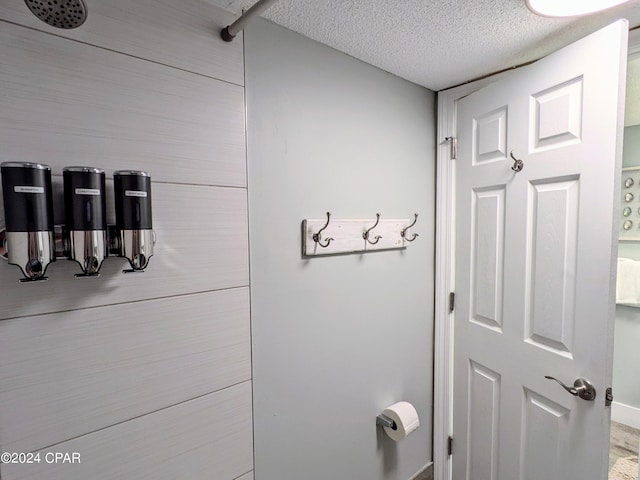 bathroom featuring a shower and a textured ceiling