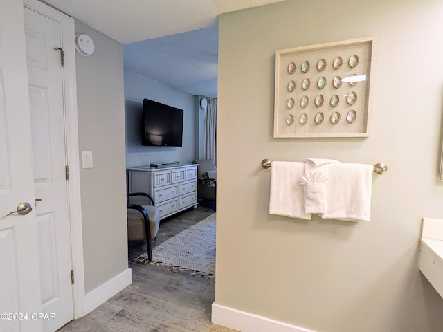 bathroom with hardwood / wood-style floors