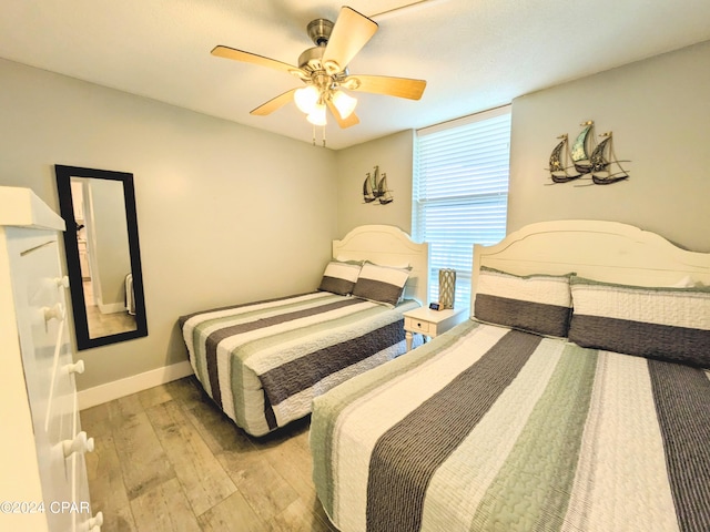 bedroom featuring ceiling fan and light hardwood / wood-style floors