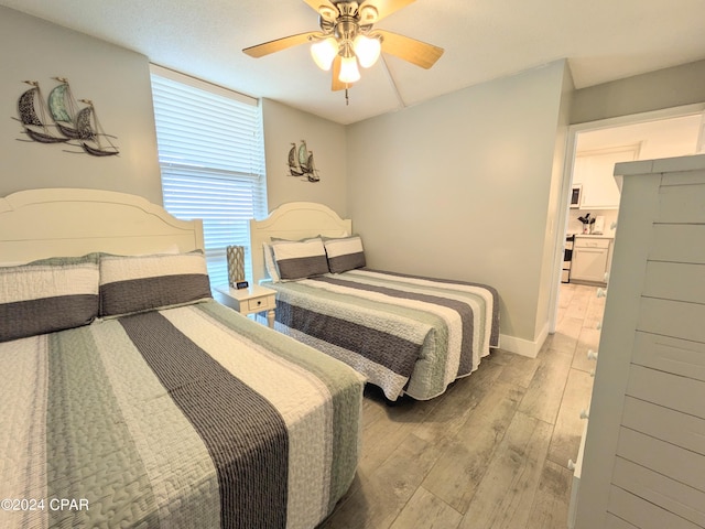 bedroom featuring hardwood / wood-style flooring and ceiling fan