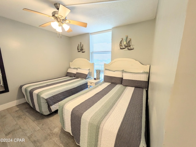 bedroom featuring wood-type flooring and ceiling fan