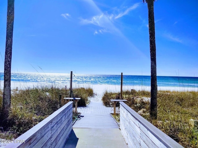 view of property's community with a view of the beach and a water view