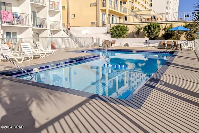 view of swimming pool with a patio