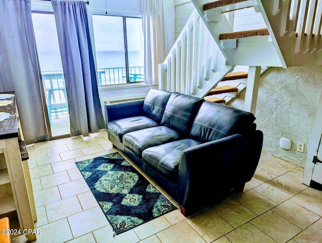 living room with a water view and light tile patterned floors