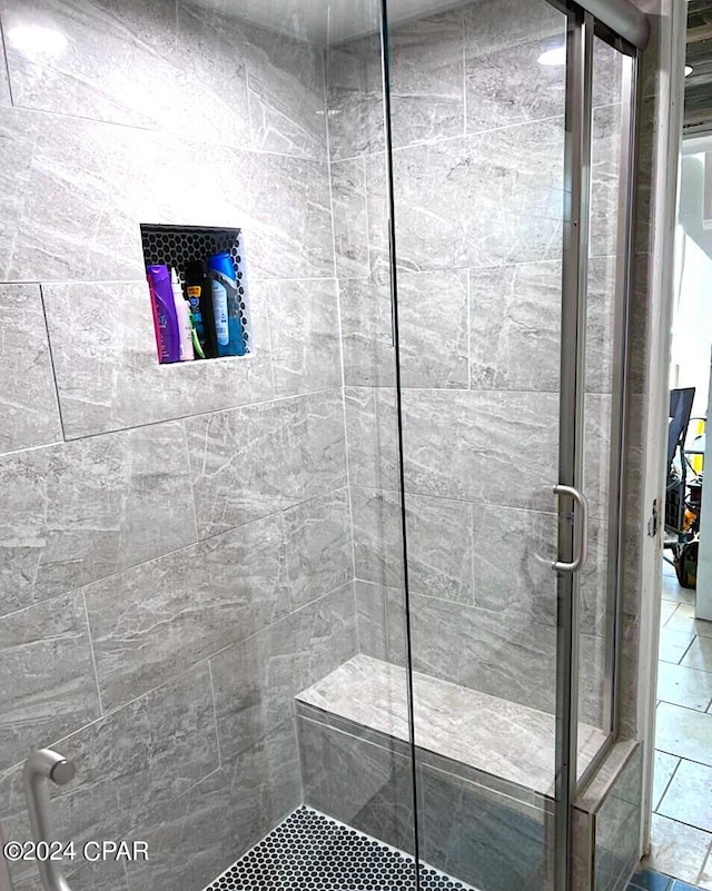 bathroom with a shower with door