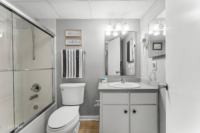 full bathroom featuring combined bath / shower with glass door, vanity, toilet, and tile patterned flooring