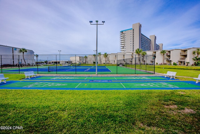 view of sport court featuring a yard