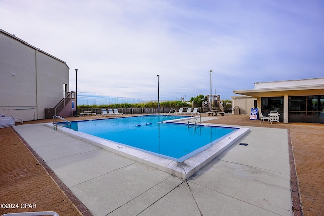 view of swimming pool with a patio