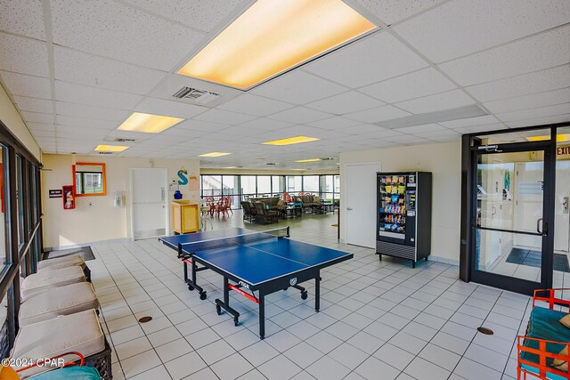 playroom featuring a wall of windows, light tile patterned floors, and a paneled ceiling