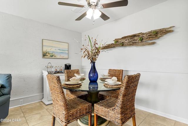 dining room with ceiling fan and light tile patterned flooring