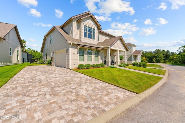 view of front of home featuring a front yard and a garage