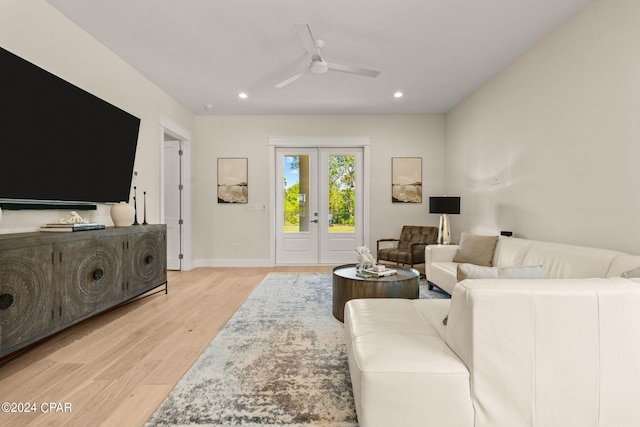 living room featuring light wood-type flooring and ceiling fan