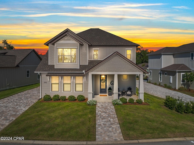 view of front of home featuring a yard and covered porch