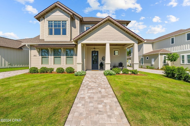 view of front of house with a porch and a front lawn