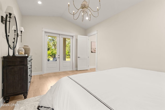 bedroom with light hardwood / wood-style floors, lofted ceiling, and a notable chandelier