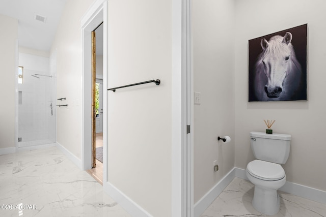 bathroom featuring walk in shower and toilet