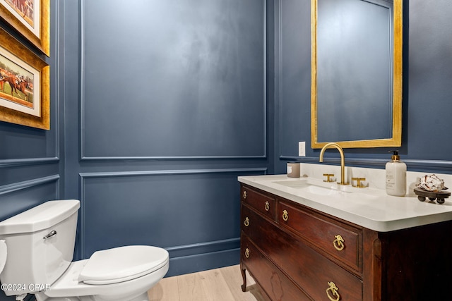 bathroom featuring hardwood / wood-style floors, vanity, and toilet